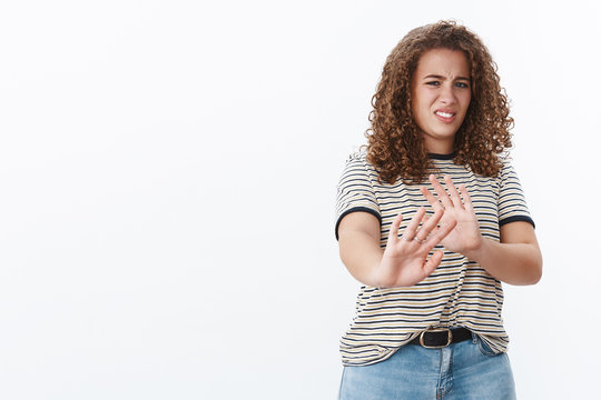 Awful take away from face. Disgusted displeased intense disliking young chubby girl restraining raise hand stop enought refusal gesture cringing aversion show reluctance, declining product