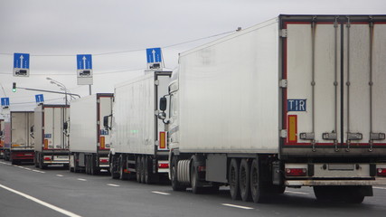 The queue traffic of many trucks with semi-trailers to the weight control point