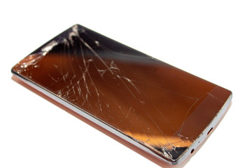 cracks on the smartphone screen. broken smartphone.