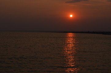 Beautiful sunset sky above the sea beach in golden hour