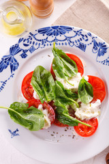 salad of fresh tomatoes, young cheese and fresh spinach.