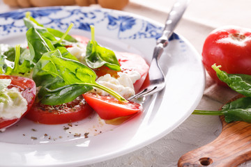 salad of fresh tomatoes, young cheese and fresh spinach.