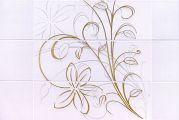 Ceramic tiles with a golden floral pattern.