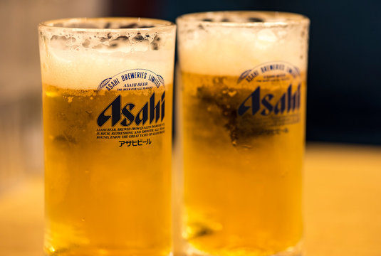 TOKYO - JAN 11: Asahi beer  with foam in a glass on wooden table in Tokyo on January 11. 2017 in Japan