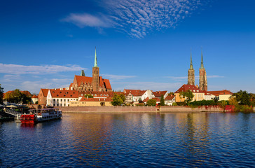 Obraz premium Sightseeing of Poland. Cityscape of Wroclaw. The view at Tumski island and Cathedral of St John the Baptist, Church of Our lady on the Sand, Odra river. 