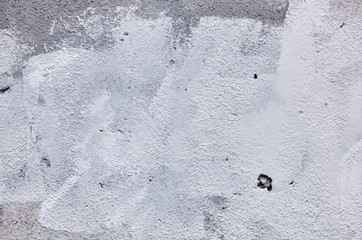 Texture of a concrete wall with cracks and scratches which can be used as a background