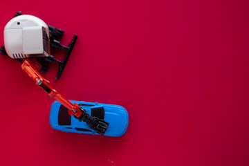 Photo of a toy car on a red background.