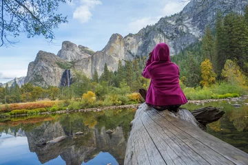 Fotobehang Back view of active woman backpacker enjoying valley and mountain view in yosemite national park,  © Supavadee