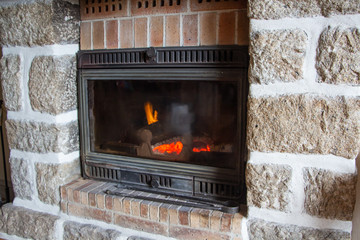 Insert in a fireplace made in stone in a living room - 298498305