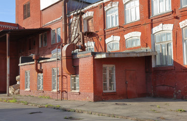 A dilapidated brick building of an old factory of the last century