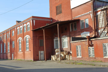 A dilapidated brick building of an old factory of the last century