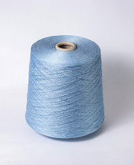 bobbin of yarn on a white background. Side view.Textile reel on isolated white background.