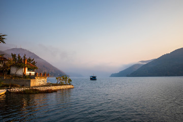 Obraz premium Boats on Danube river at sunrise near the Donji Milanovac in Serbia