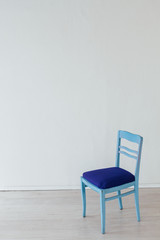one chair in the interior of an empty white room