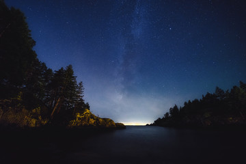 Fototapeta na wymiar The magical and ethereal night sky with views of the milky way, nebulas, and stars within the Pacific North West's Bowen Island in stunning British Columbia Canada.