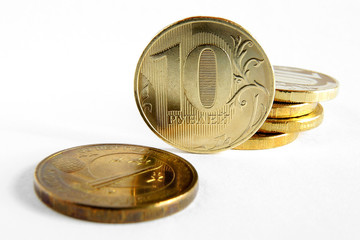 Russian coins at 10 rubles. Money lies on a white paper background. Not isolated. News on lending to individuals, banks, microfinance and microcredit companies. Macro