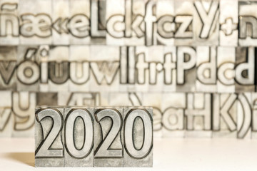Happy new year 2020 on background with press types