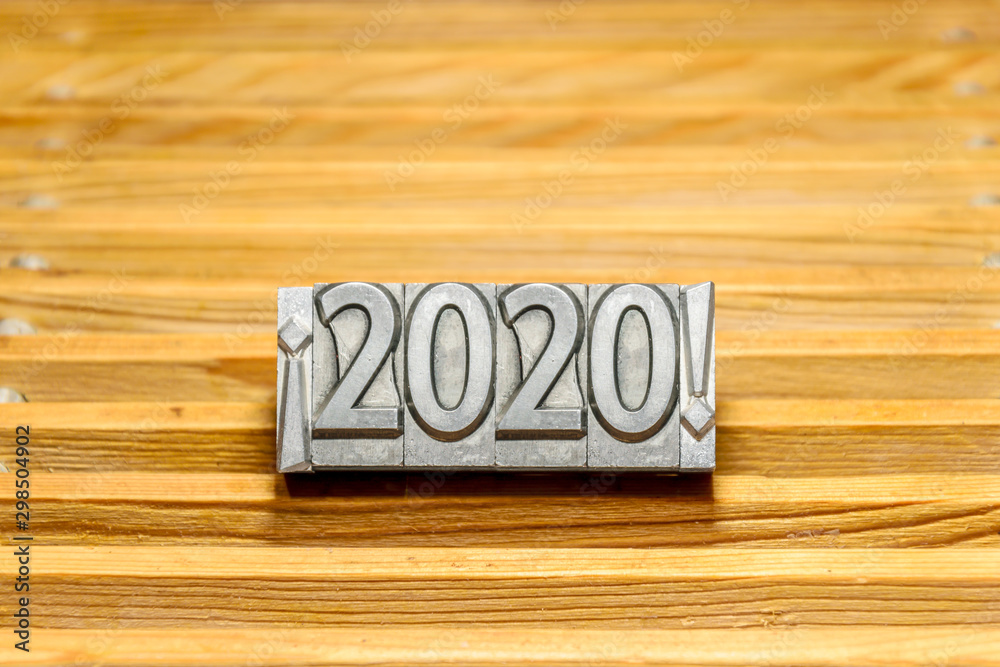 Fototapete happy new year 2020 on wooden slats background with types of press between exclamation marks