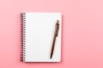 the white open notepad isolated on the pink background