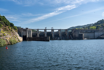 Solid structure of the Carrapatelo dam on River Douro in Portugal with the lock gates on the left