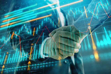 Multi exposure of forex graph on abstract background with two businessmen handshake. Concept of success on stock market