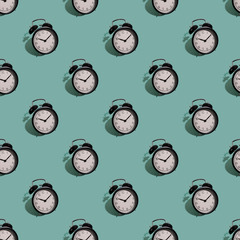 Many black classic style alarm clock with hard shadow isolated on green background. Smile time concept. Seamless pattern © Nataliya