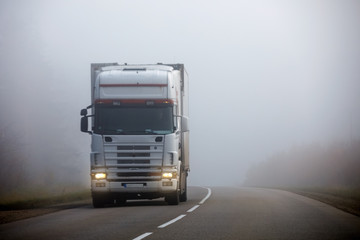 Truck on the road in the fog