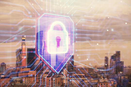 Double exposure of lock icon hologram on cityscape background. Concept of data security