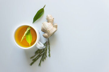 Cup of hot tea with ginger and rosemary. Concept - prevention of colds and flu, patient care....