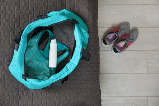 Deodorant In Gym Bag On Bed, Top View