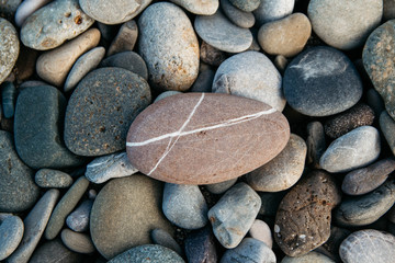 Gravel pattern of colored stones. Abstract nature pebbles background. Stone background. Sea peblles beach. Top view.