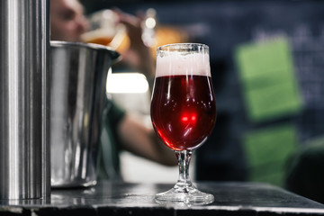 Glass of beer on bar counter in pub