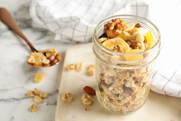 Tasty homemade granola on white marble table. Healthy breakfast
