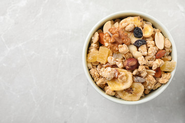 Tasty homemade granola on light table, top view with space for text. Healthy breakfast