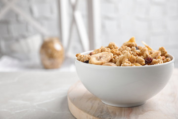 Tasty homemade granola on light table in kitchen, space for text. Healthy breakfast