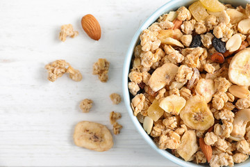 Tasty homemade granola on white wooden table, top view. Healthy breakfast