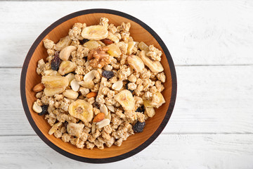 Tasty homemade granola on white wooden table, top view. Healthy breakfast