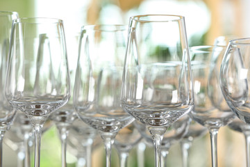 Empty glasses against blurred background, closeup view