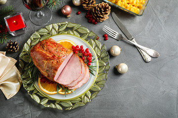Flat lay composition with delicious ham served on grey table. Christmas dinner