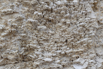 white stone damaged wall background of limestone
