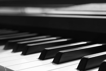 Naklejka premium Modern piano with black and white keys indoors, closeup
