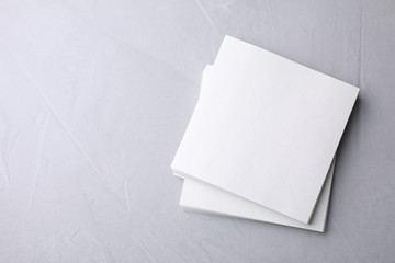 Blank note papers on light grey background, top view. Mock up for design