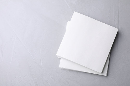 Blank note papers on light grey background, top view. Mock up for design © New Africa