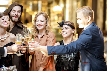 Well-dressed people celebrating New Year indoors