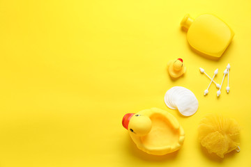 Flat lay composition with baby cosmetic products on yellow background. Space for text