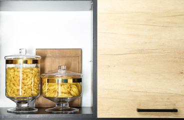 Products in modern kitchen glass containers on shelf