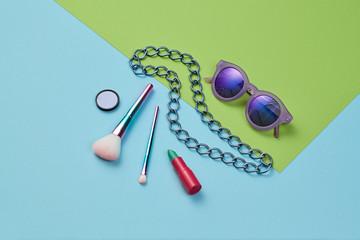 Fashion beauty product layout. Woman Essentials cosmetic Set. Collection party accessories. Trendy sunglasses, Brushes, lipstick. Coloful vibrant art Flat lay. Creative minimalconcept