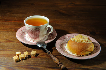 tea with a bun on an old kitchen table2