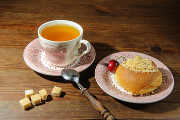 tea and bun with cherry on a wooden table1