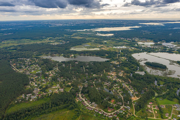 Fototapeta na wymiar Beautiful landscape. Latvian nature. Forest, town and lakes. View from above.